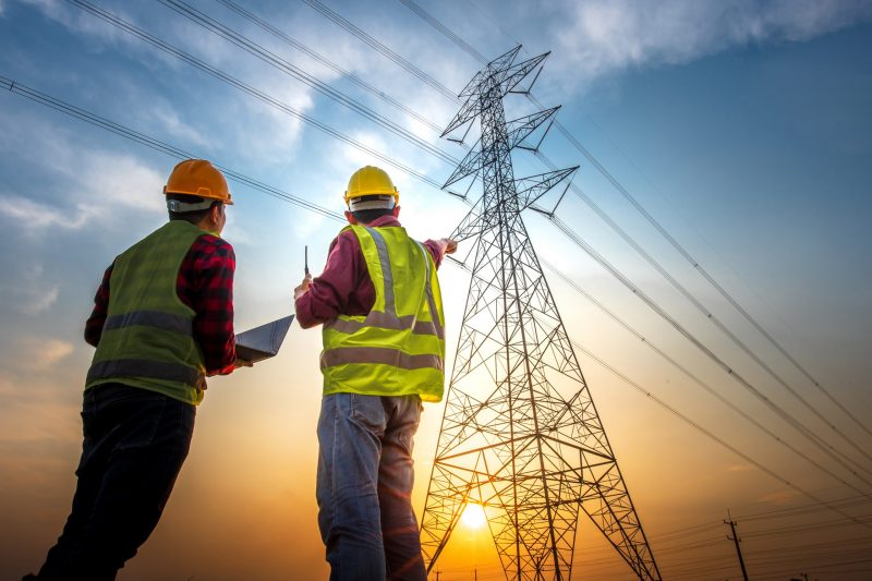 Picture of two electrical engineers checking electrical work usi electric pole, check electrical work, computer, success, high voltage pole, see, asia, powerful, asian, generator, helmet, production, power station, electric power, electricity, electrical engineer, blue, volt, grid, worker, technician, pylon, pole, engineer, electronic, repair, silhouette, watt, technology, maintenance, steel, work, transmission, equipment, circuit, structure, electrician, cable, distribution, station, high, tower, electrical, danger, energy, industry, power, electric, voltage, industrial